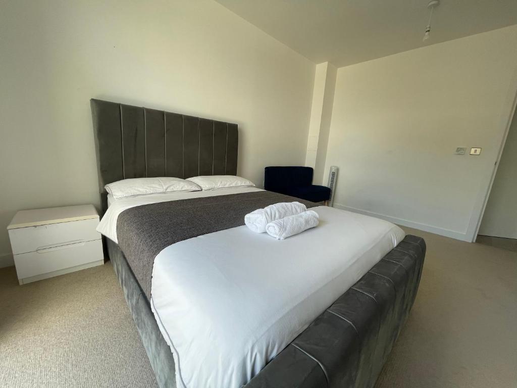 a bedroom with a large bed with a black headboard at The Perfect inn in London