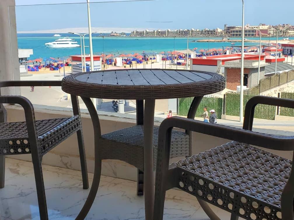 a table and chairs with a view of a beach at Hurghada Pearl in Hurghada