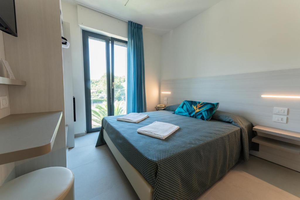 Postel nebo postele na pokoji v ubytování Hotel La Bussola