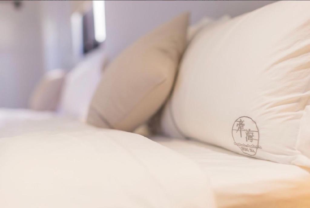 Postel nebo postele na pokoji v ubytování Penghu Swing Sea Homestay