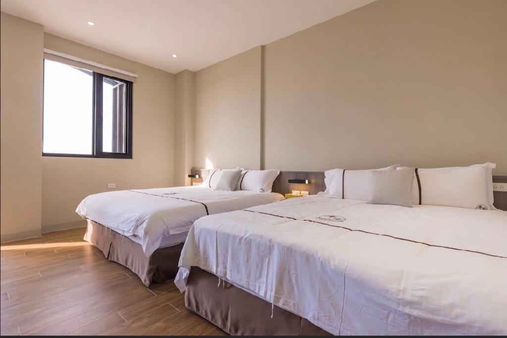 Postel nebo postele na pokoji v ubytování Penghu Swing Sea Homestay