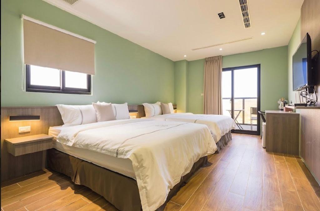 Postel nebo postele na pokoji v ubytování Penghu Swing Sea Homestay