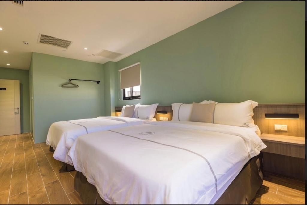 Postel nebo postele na pokoji v ubytování Penghu Swing Sea Homestay
