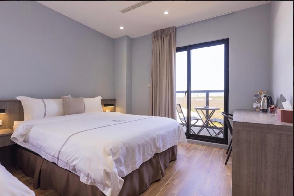 Postel nebo postele na pokoji v ubytování Penghu Swing Sea Homestay