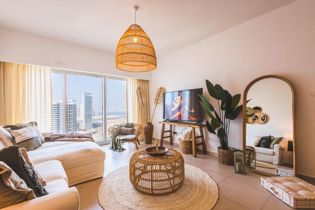 a living room with a couch and a table at Voyage Two Bedroom In Reem Island in Abu Dhabi