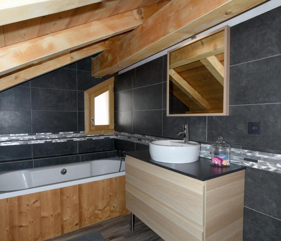 a bathroom with a sink and a bath tub at Chalet Loan in Montgenèvre