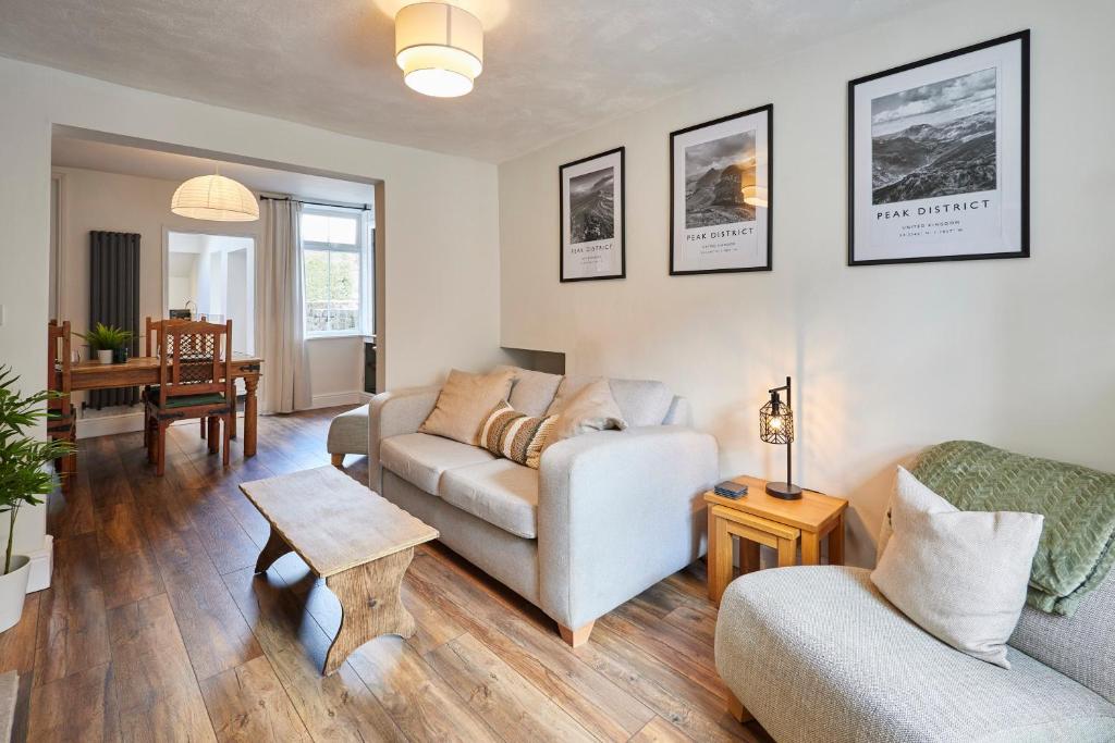 a living room with a couch and a table at Church View Cottage & Secret Garden, Matlock - Now Hosted by StayHostSave in Matlock