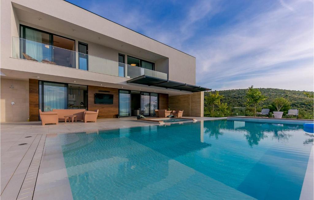 a house with a swimming pool in front of it at Villa Korina in Primošten