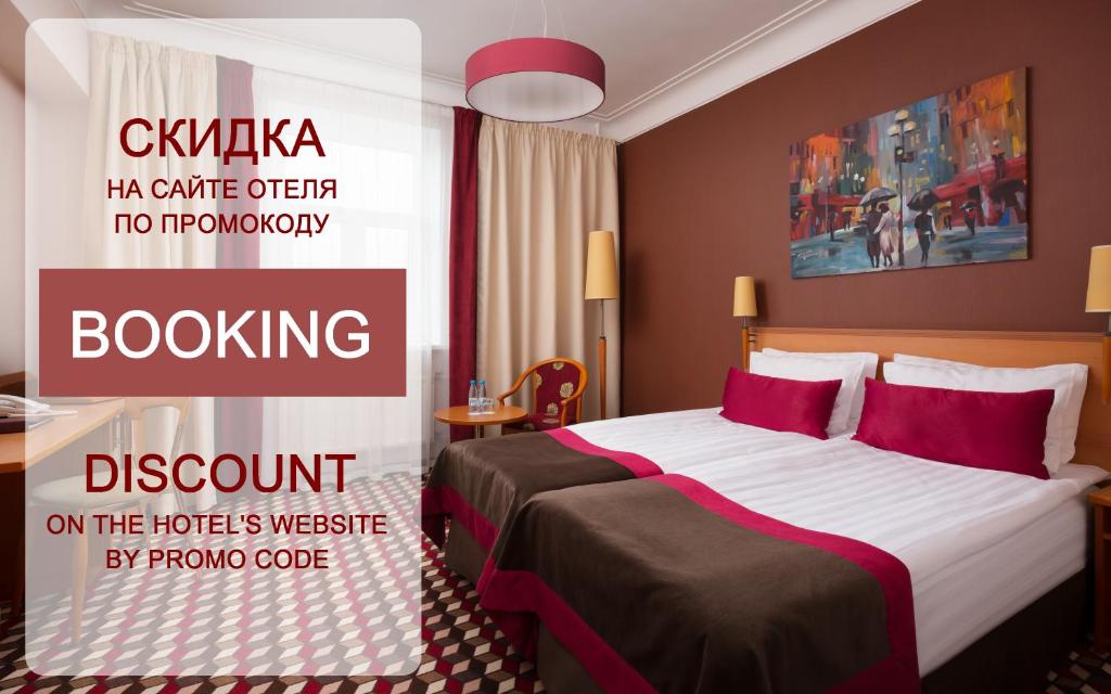 a hotel room with a bed with red pillows at Oktiabrskaya Hotel in Saint Petersburg