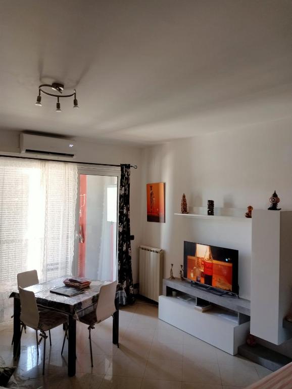 a living room with a table and a fireplace at AiRPORT ALEXANDER in Genoa