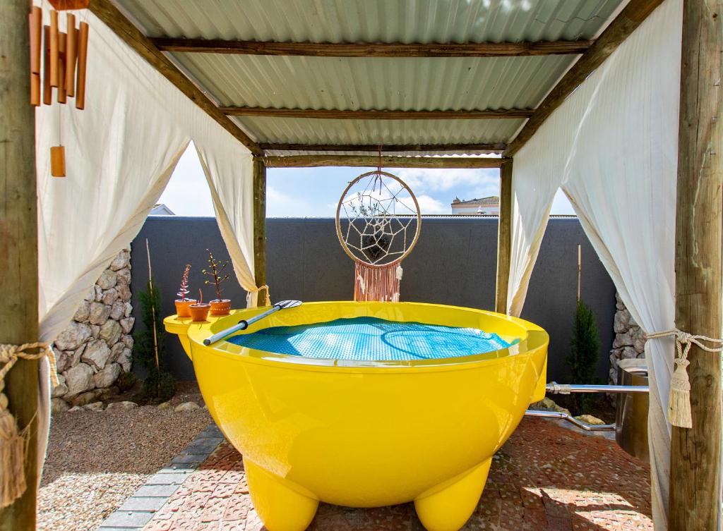a large yellow bath tub sitting under a tent at Dunes, Waves and Shells Self Catering Units and The Beach Shack Caravan Langebaan in Langebaan