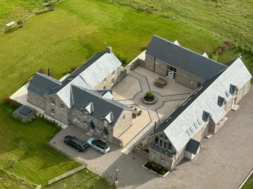 an aerial view of a large stone house with a yard at Kipney Hunting Lodge in Perth