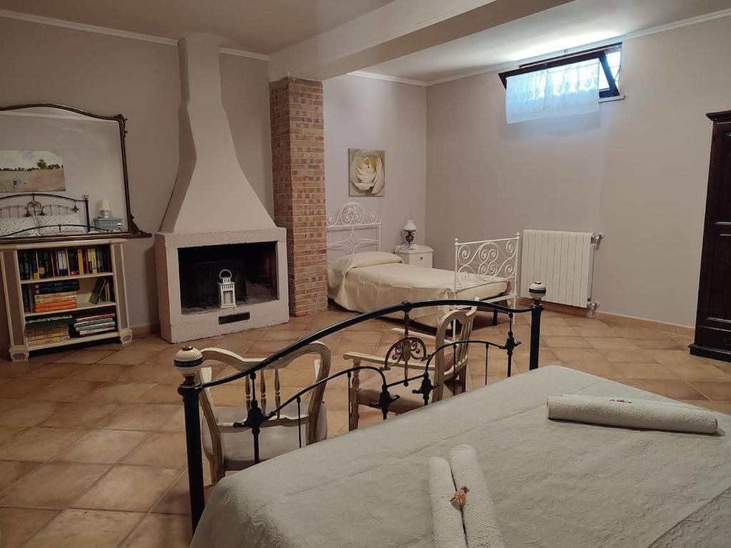a living room with two beds and a fireplace at Il Nido in Fiano Romano