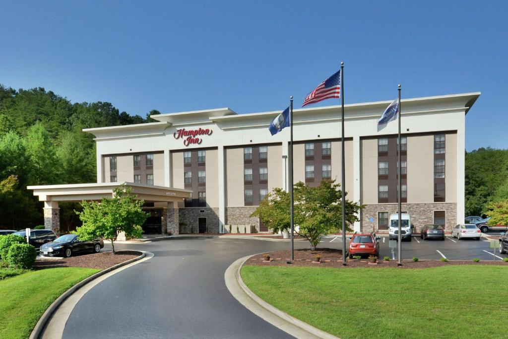 a hotel with two american flags in front of it at Hampton Inn Martinsville in Martinsville