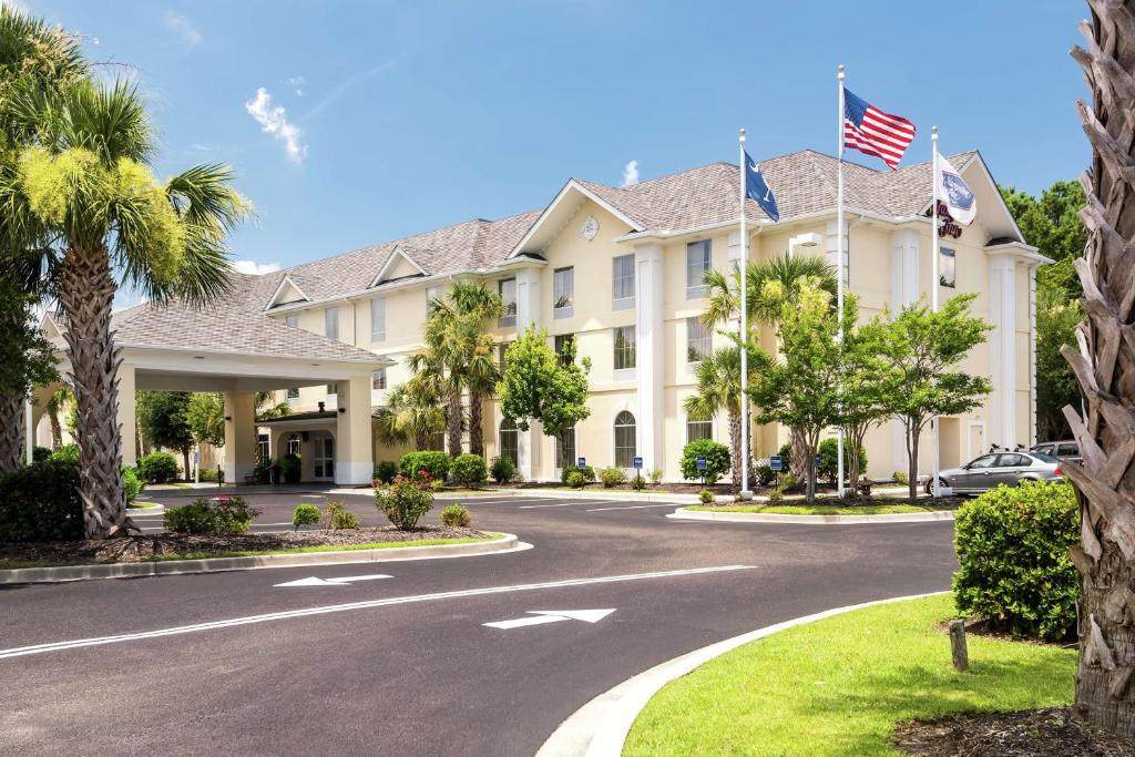 a large white building with an american flag at Hampton Inn Murrells Inlet/Myrtle Beach Area in Myrtle Beach