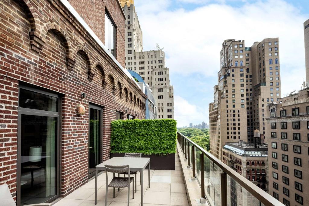 a balcony with a table and chairs on a building at Hilton Club The Quin New York in New York