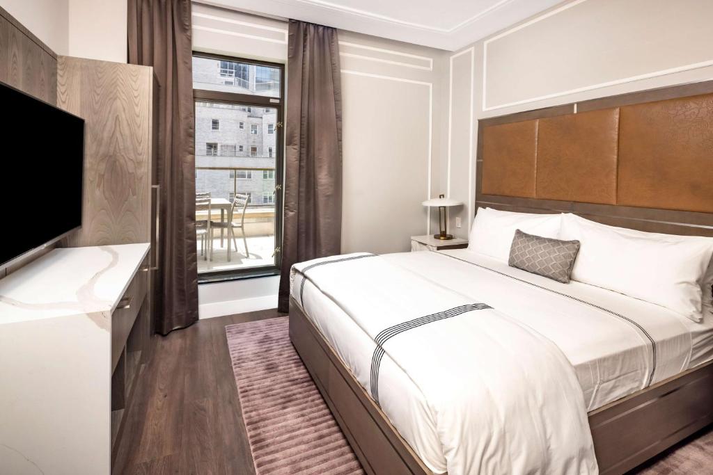 a hotel room with a bed and a television at Hilton Club The Quin New York in New York