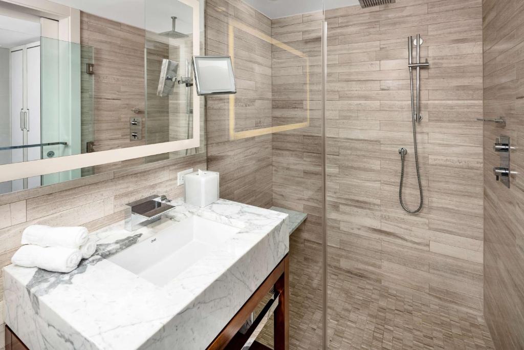 a bathroom with a sink and a shower at Hilton Club The Quin New York in New York