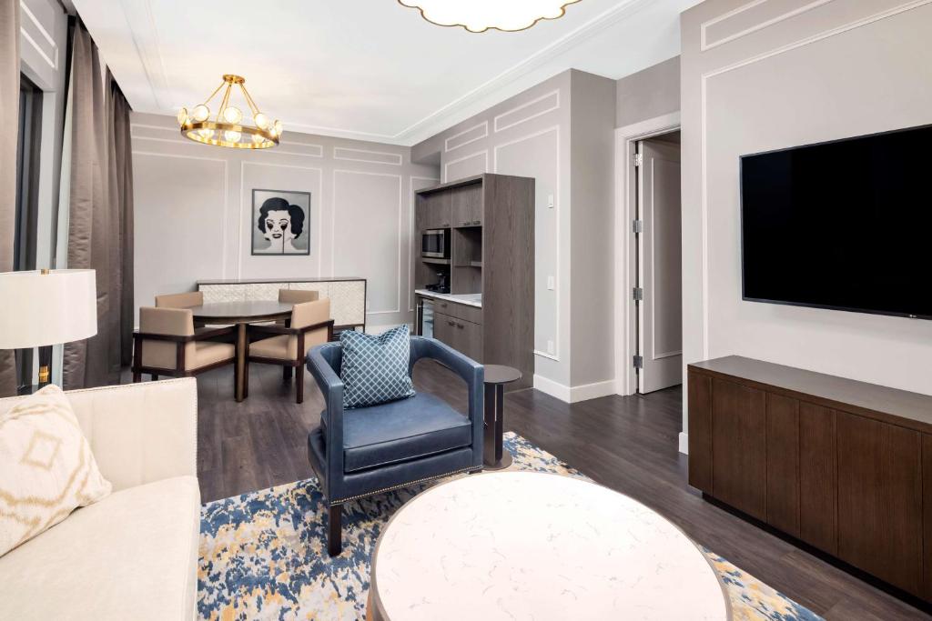 a living room with a couch and a tv at Hilton Club The Quin New York in New York