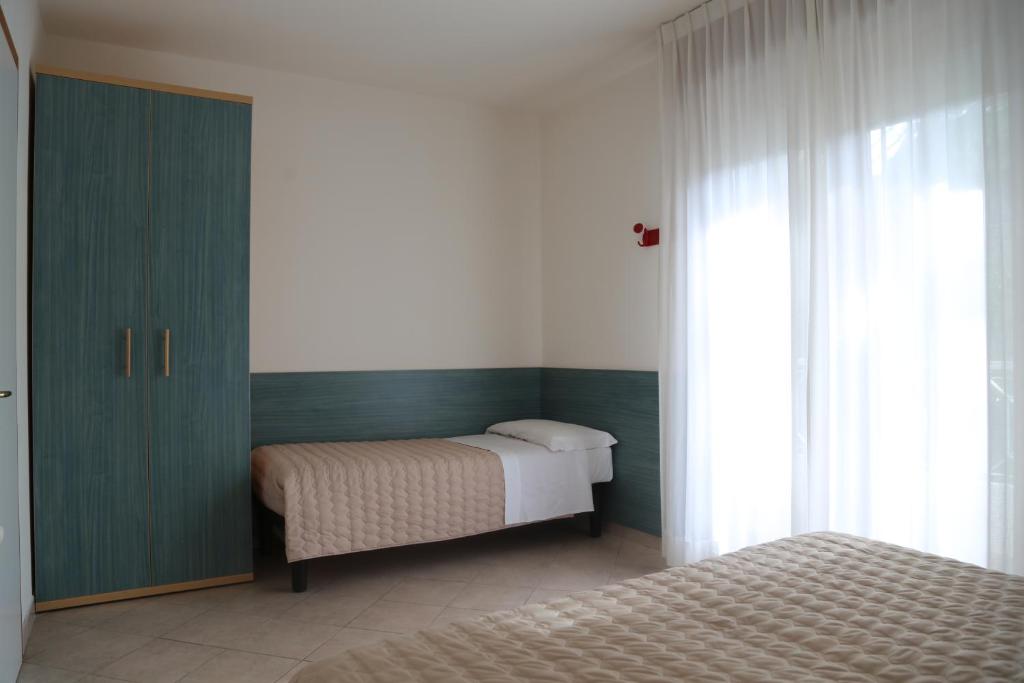 Кровать или кровати в номере Villaggio Mare Blu
