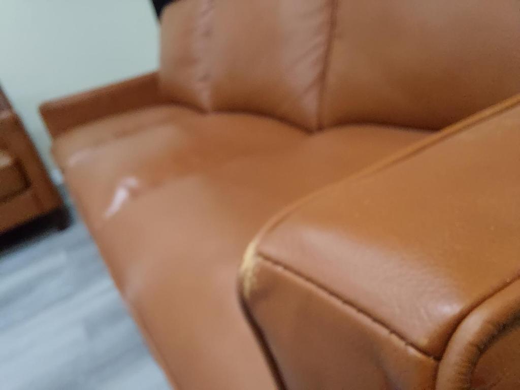 a close up of a brown leather couch at Casa Cerca De La Playa in Chicago