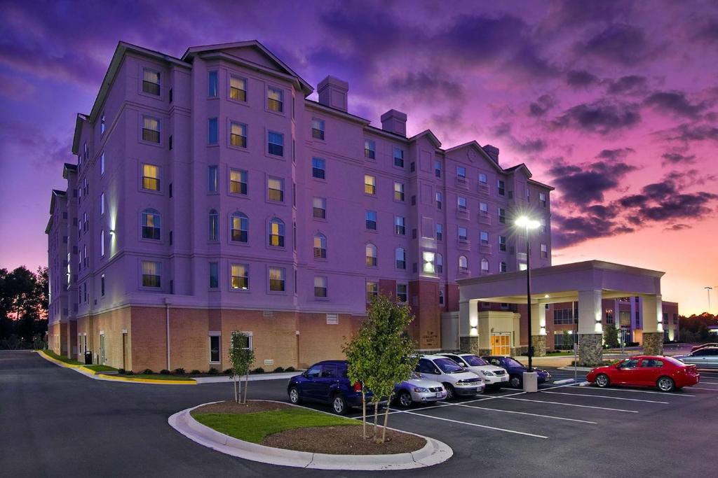 a purple building with cars parked in a parking lot at Homewood Suites by Hilton Virginia Beach in Virginia Beach