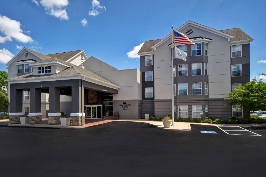 a hotel with an american flag in a parking lot at Homewood Suites by Hilton Philadelphia-Great Valley in Malvern