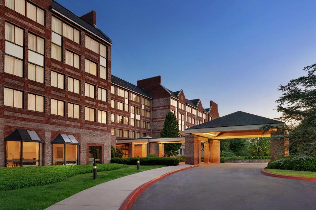 an exterior view of a building with a driveway at Embassy Suites by Hilton Philadelphia Valley Forge in Wayne