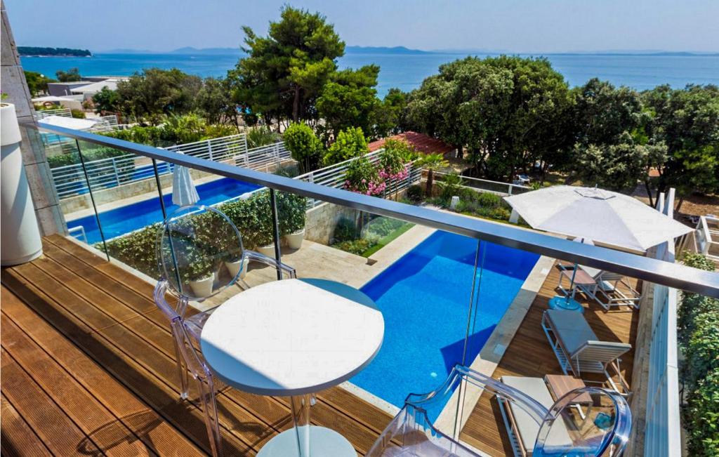 a balcony with a view of a swimming pool at Villa Magnolia in Petrcane
