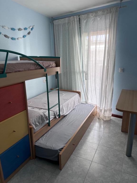 a bedroom with two bunk beds and a window at Mont-Roig Del Camp in Tarragona