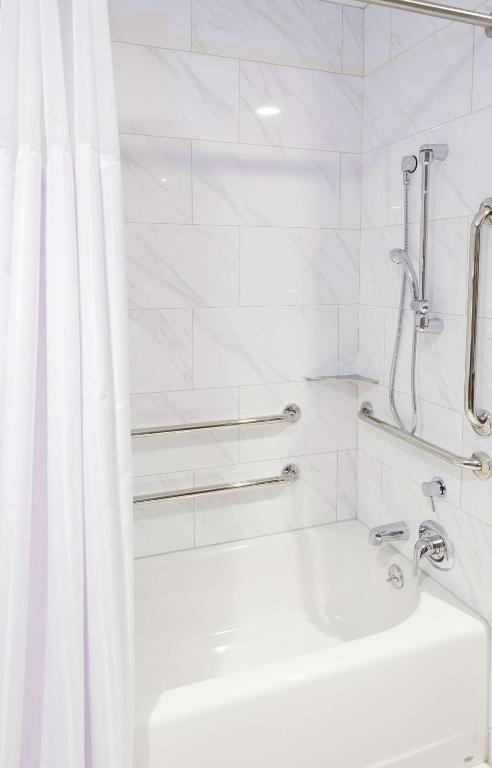 a white bathroom with a shower and a sink at Hilton Garden Inn Phoenix Downtown in Phoenix