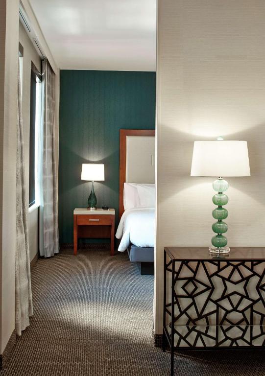 a bedroom with a bed and a lamp on a table at Hilton Garden Inn Phoenix Downtown in Phoenix