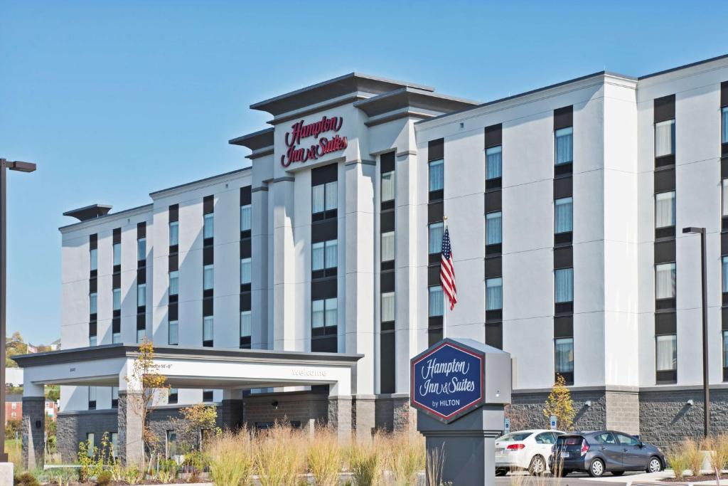 a hotel building with a sign in front of it at Hampton Inn & Suites North Huntingdon-Irwin, PA in Irwin