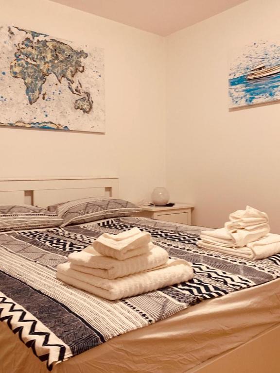 a bed with towels sitting on top of it at Hiška on the cliff in Ankaran