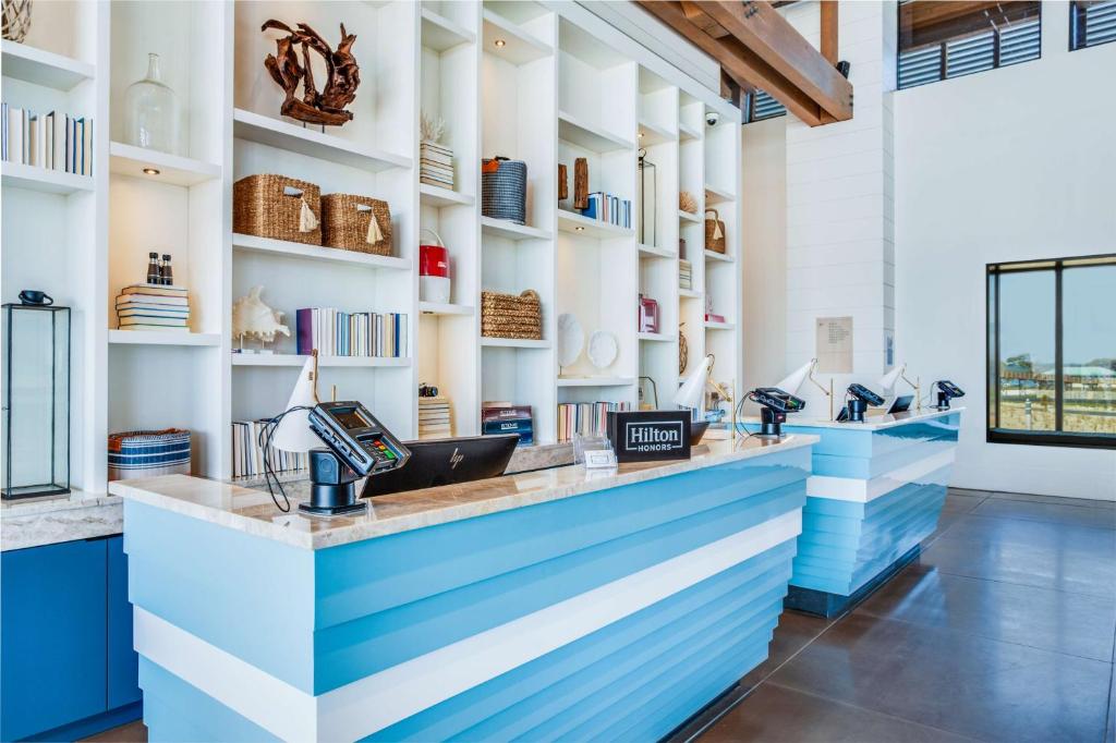 a store with a blue and white counter at The Lodge at Gulf State Park, A Hilton Hotel in Gulf Shores