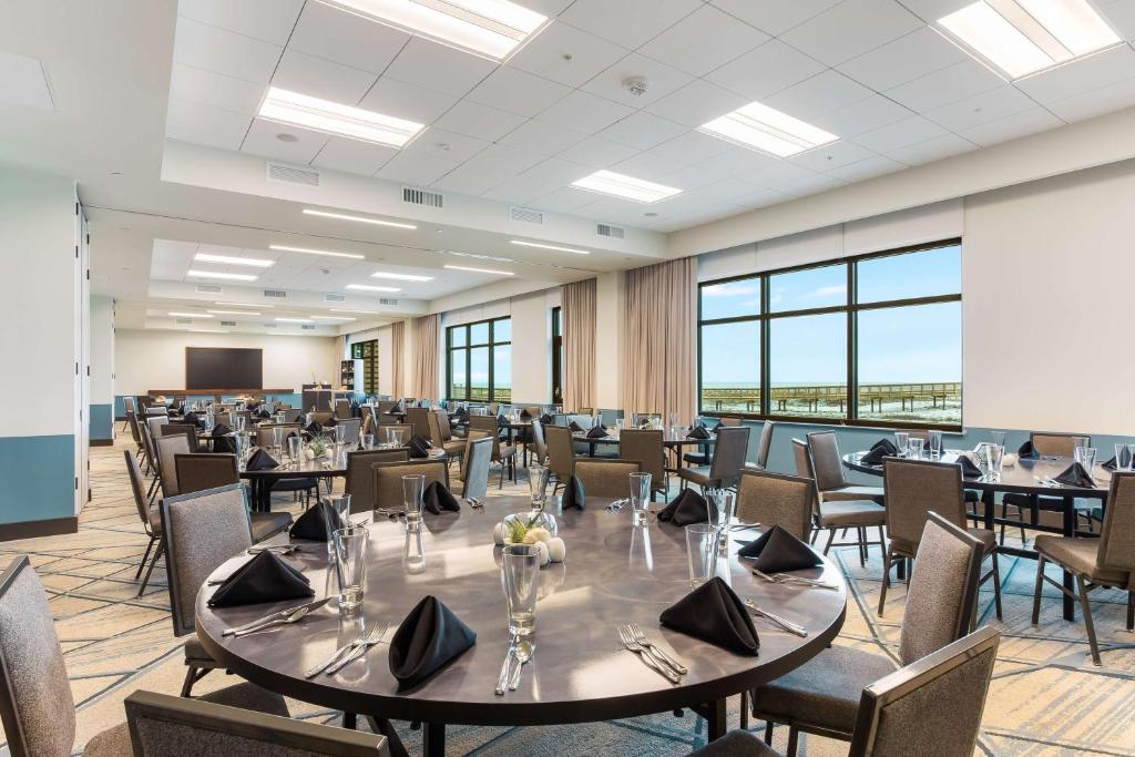 a conference room with a large table and chairs at The Lodge at Gulf State Park, A Hilton Hotel in Gulf Shores