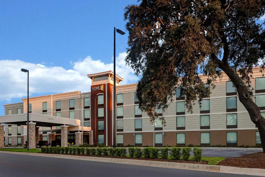 um edifício de escritórios com uma torre de relógio em frente em Home2 Suites by Hilton Gulf Breeze Pensacola Area, FL em Gulf Breeze