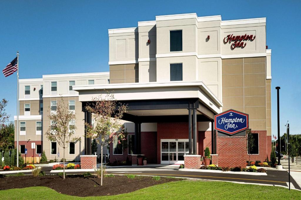 a hotel building with a sign in front of it at Hampton Inn Lewiston-Auburn in Lewiston