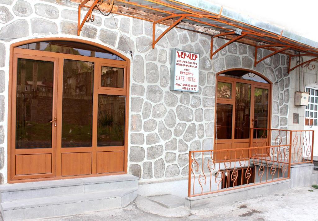 a building with two doors and a sign on it at NarVar Hotel in Goris