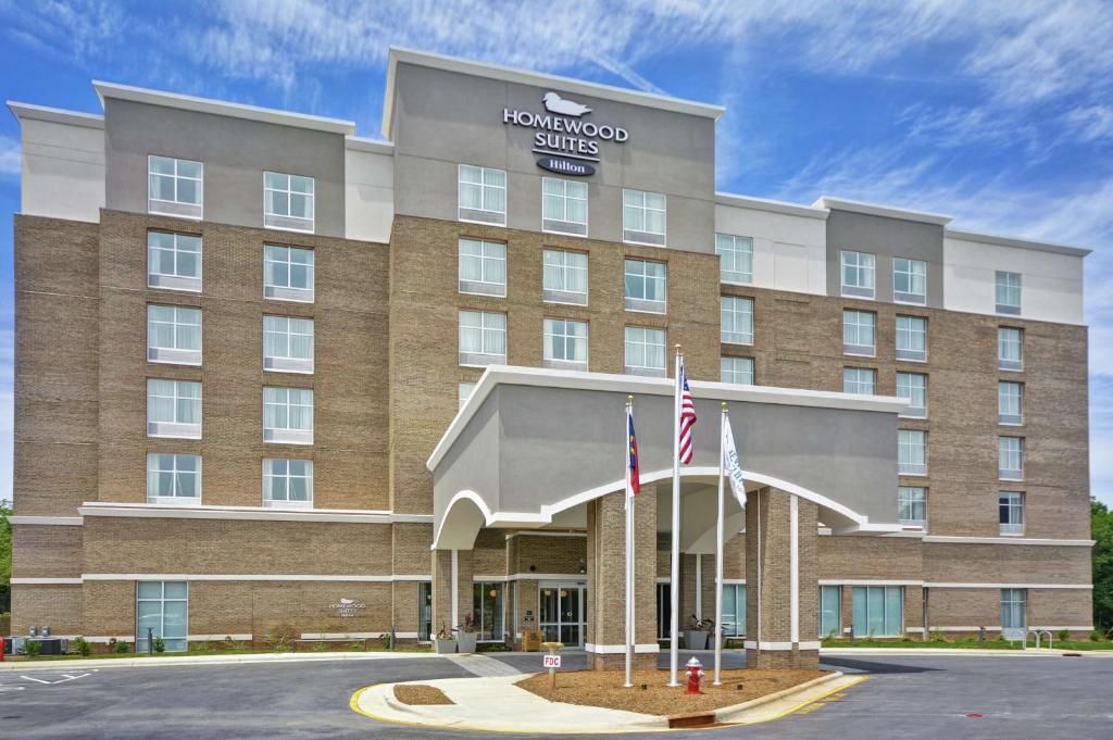 budynek hotelowy z dwoma flagami przed nim w obiekcie Homewood Suites by Hilton Raleigh Cary I-40 w mieście Cary