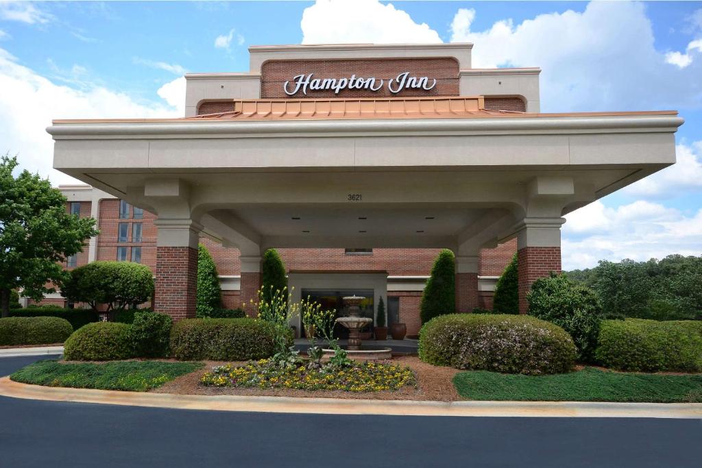a building with a sign on top of it at Hampton Inn Raleigh Capital Blvd North in Raleigh