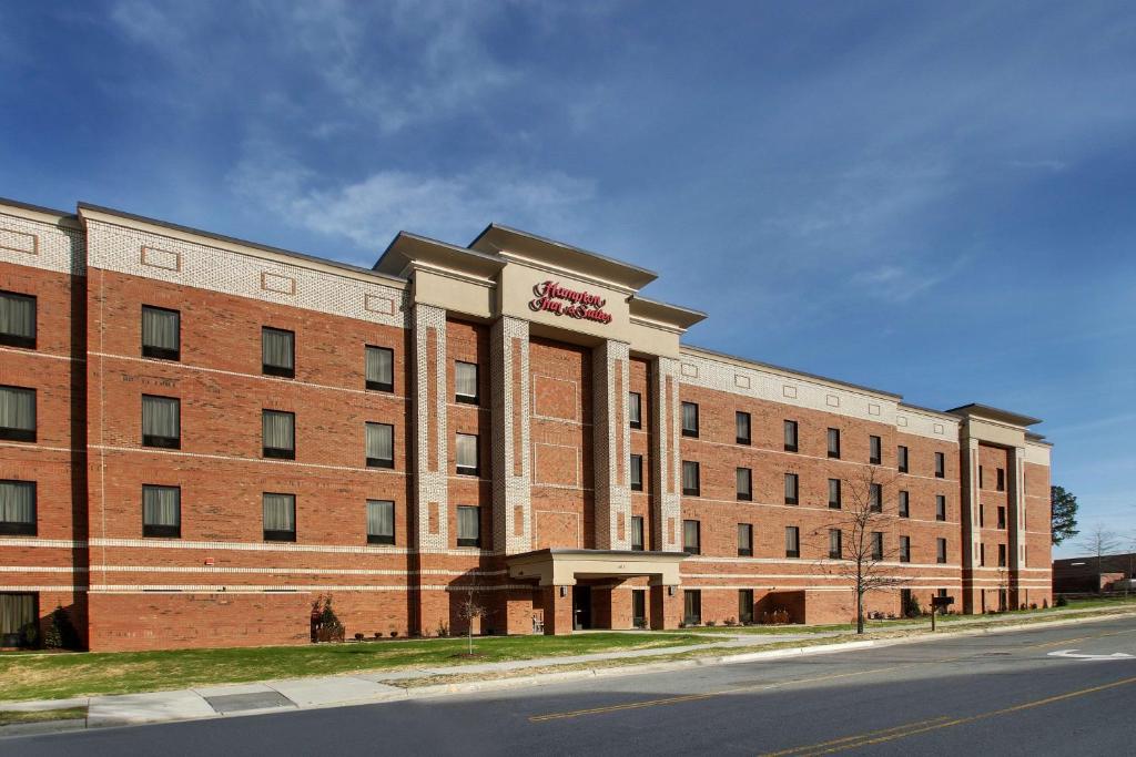 a large brick building on the side of a street at Hampton Inn & Suites By Hilton Knightdale Raleigh in Raleigh
