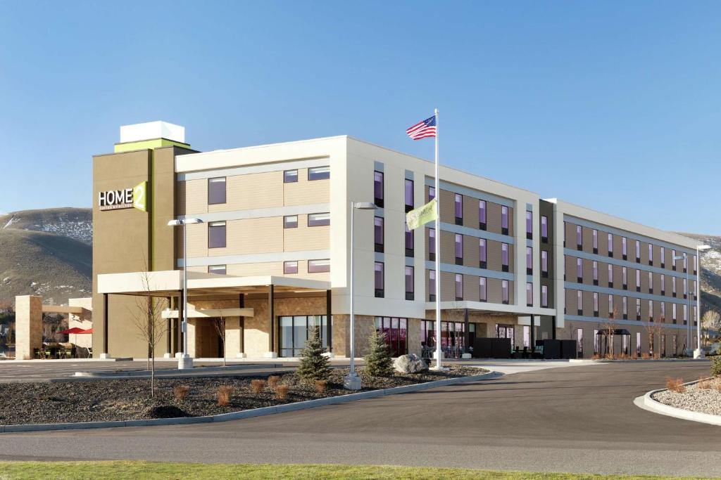 a building with an american flag in front of it at Home2 Suites By Hilton Richland in Richland