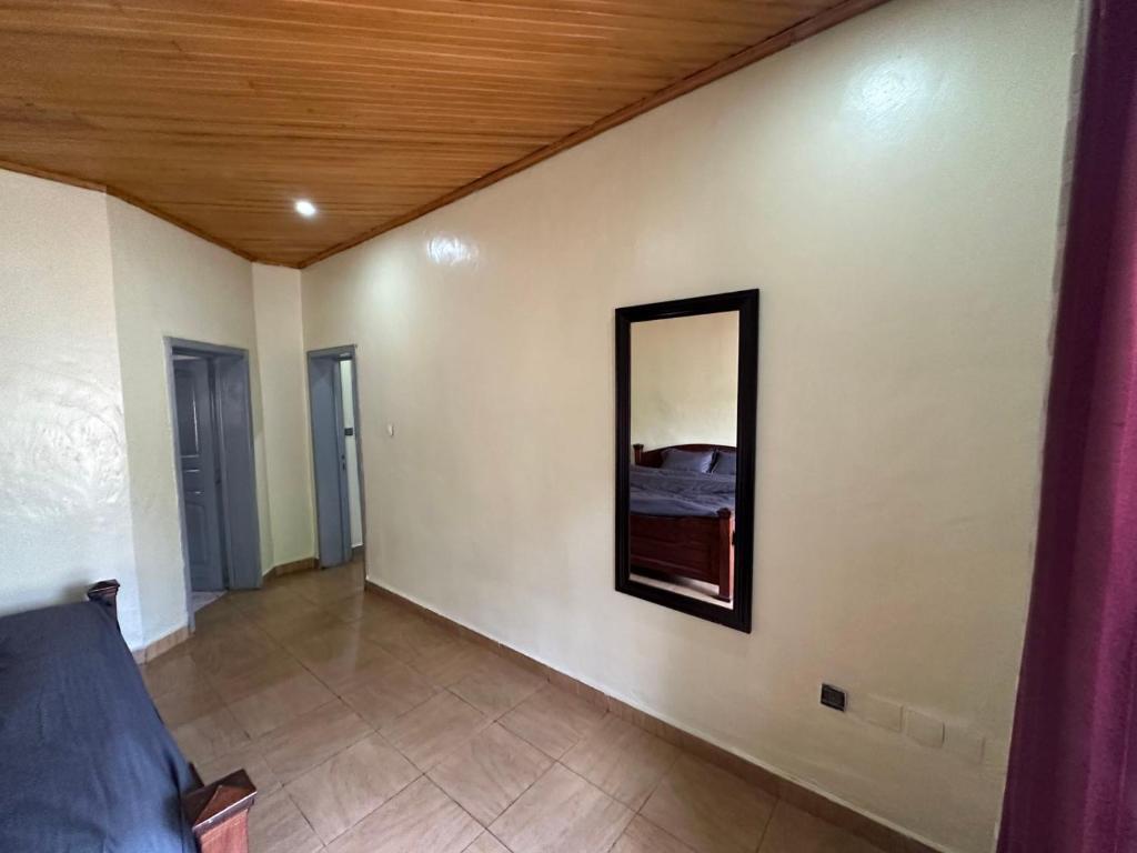 a living room with a mirror on the wall at Deer Hotel in Kigali
