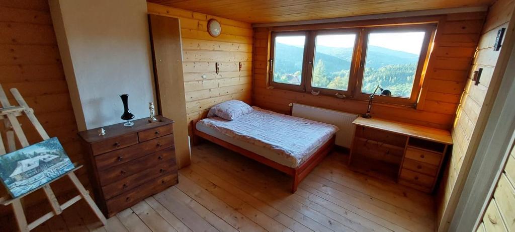 a small room with a small bed and a window at 650m n.p.m. in Zawoja