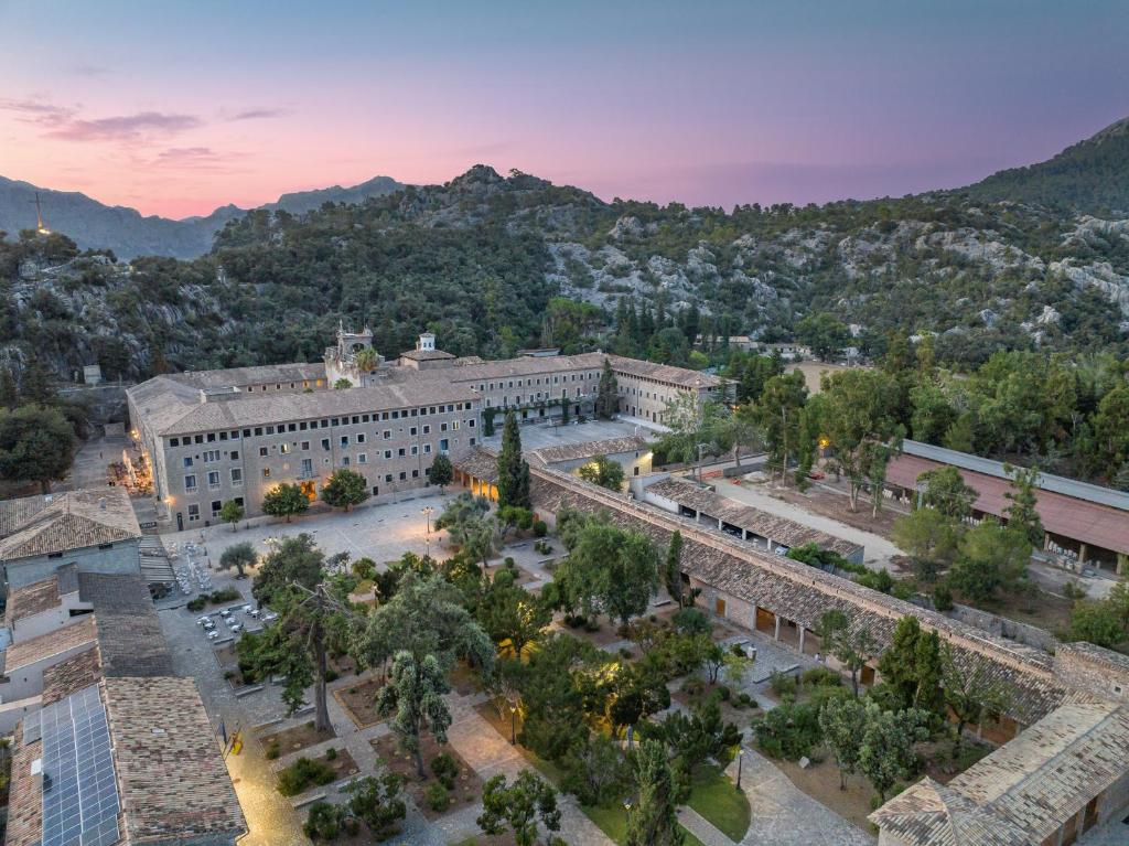 an aerial view of a building with trees and mountains at Santuari de Lluc in Lluc