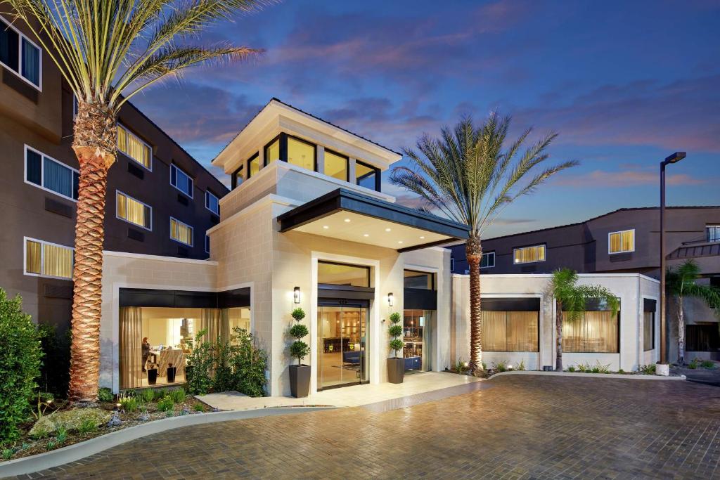 a building with palm trees in front of it at Hilton Garden Inn San Diego Mission Valley/Stadium in San Diego