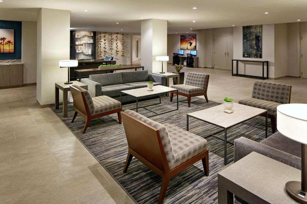 a hotel lobby with couches and tables and a piano at Hilton Garden Inn San Diego Mission Valley/Stadium in San Diego
