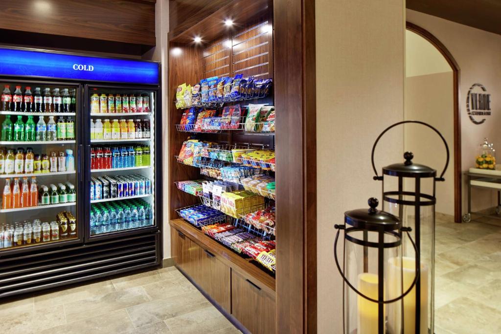 a grocery store with a large refrigerator filled with drinks at Hilton Garden Inn San Diego Mission Valley/Stadium in San Diego