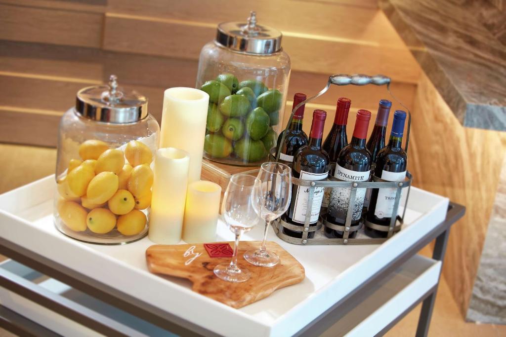 a table with wine glasses and bottles and grapes at Hilton Garden Inn San Diego Mission Valley/Stadium in San Diego